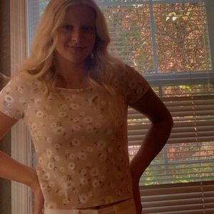 Floral shirt with a beige base.